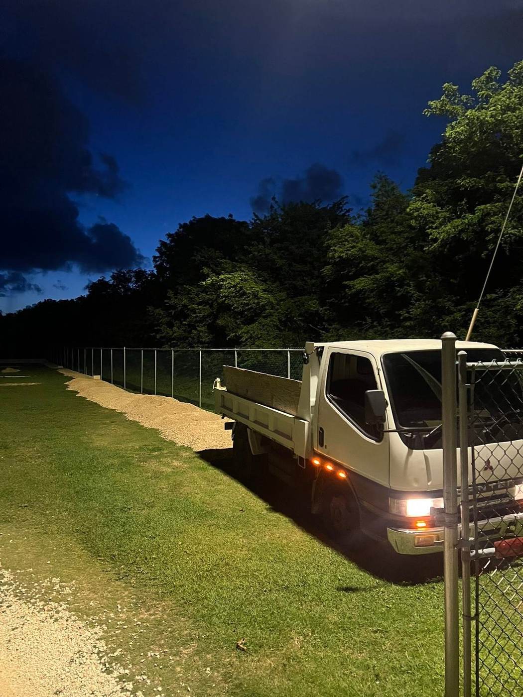 Rivers Landscaping delivery truck on site at dusk in Grand Cayman