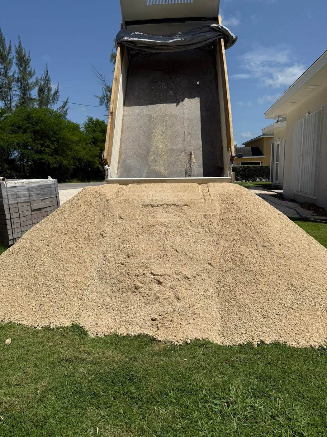 Dump truck pouring sand for a Cayman Islands project