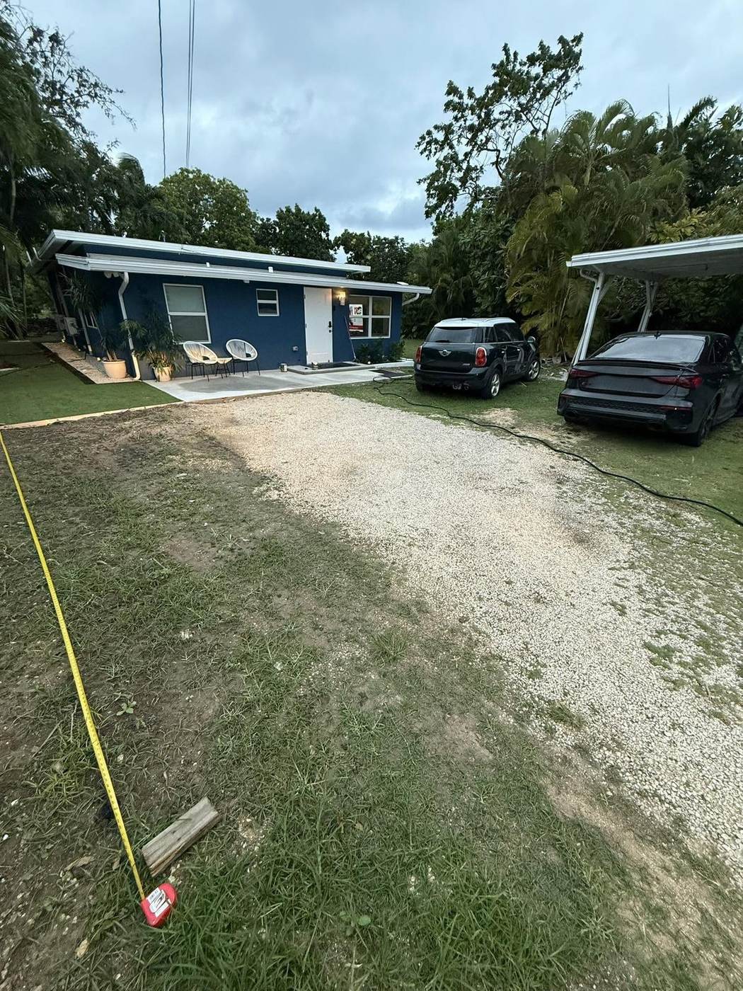 Gravel driveway grading in progress at twilight, Grand Cayman